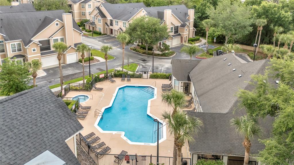 An aerial view shows a swimming pool and hot tub surrounded by apartment buildings — 1995 ERVING CIRCLE UNIT 208, OCOEE, FL