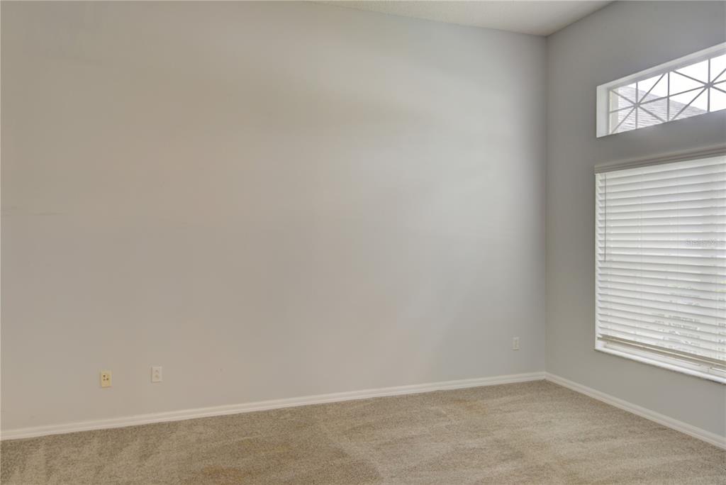 An empty room with light gray walls, beige carpet, and a window with blinds — 2688 SUGAR PINE RUN, OVIEDO, FL
