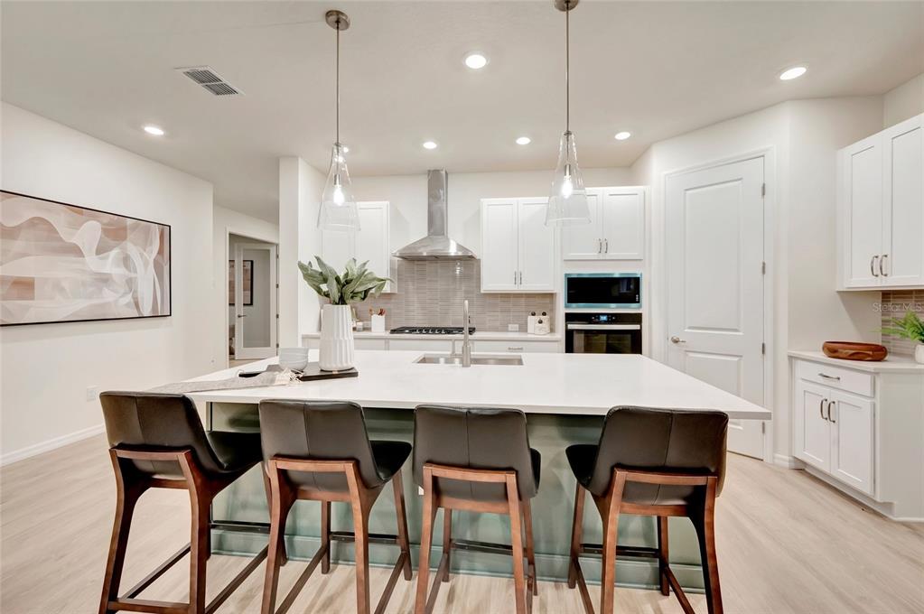 This is a digital design board showing kitchen finish samples, including cabinetry, flooring, hardware, and fixtures — 5169 SEA BRANCH AVENUE, APOLLO BEACH, FL