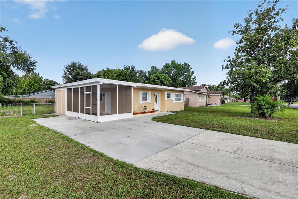 A single-story house with a screened-in porch and a concrete driveway in a grassy yard — 208 PALMYRA DRIVE, ORLANDO, FL