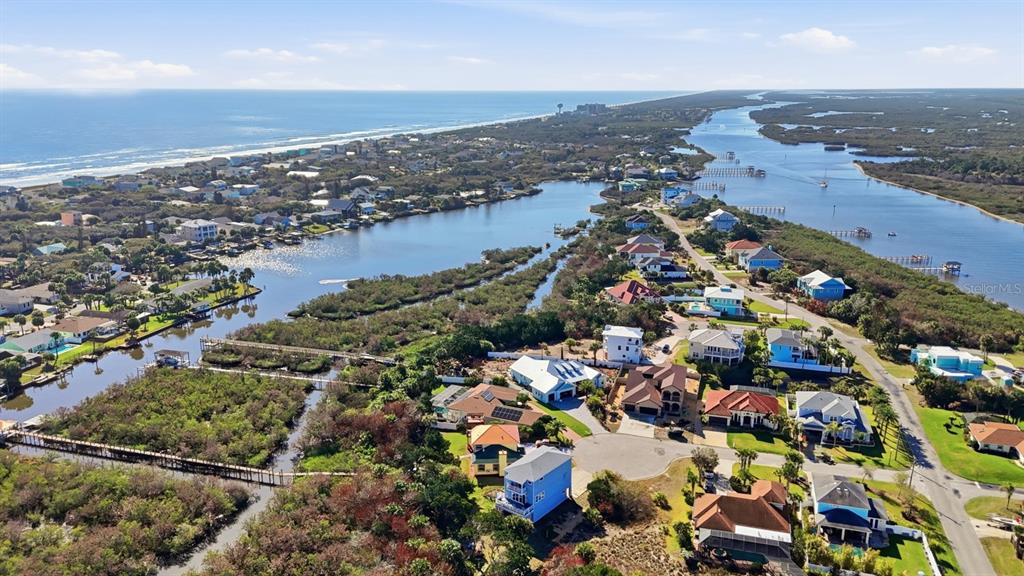 An aerial view shows coastal homes situated between the ocean and an inland waterway — 570 SPRINGDALE DRIVE, FLAGLER BEACH, FL