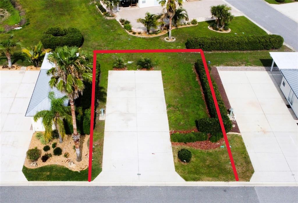 An aerial view shows a rectangular concrete pad outlined in red between two residential properties — 9450 SE 47TH WAY, WEBSTER, FL