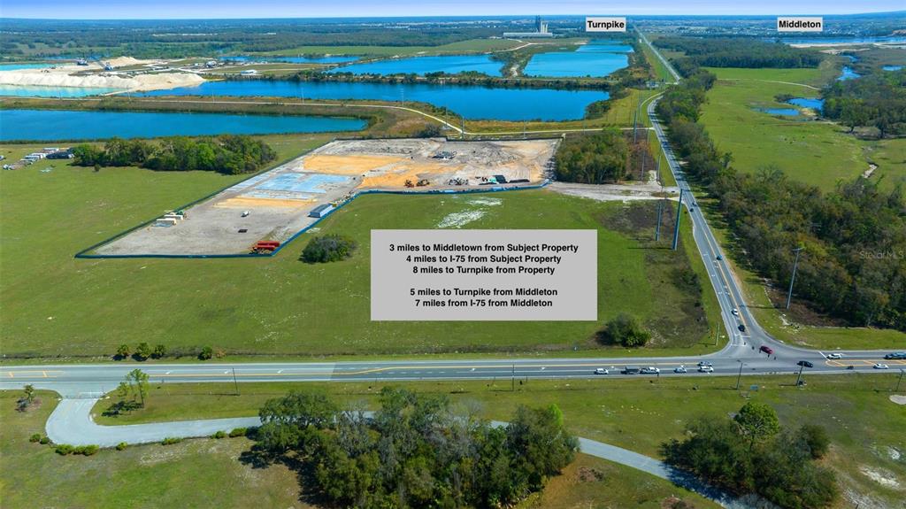 This aerial view shows a cleared construction site with nearby lakes and road access — TBD 470 HIGHWAY, SUMTERVILLE, FL