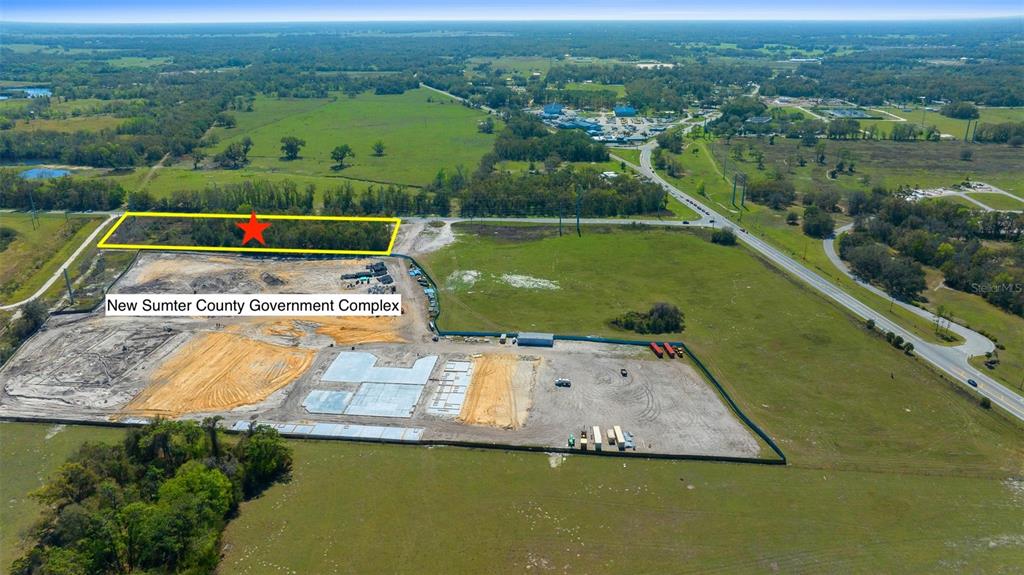 An aerial view shows a construction site for a government complex next to a wooded lot — TBD 470 HIGHWAY, SUMTERVILLE, FL