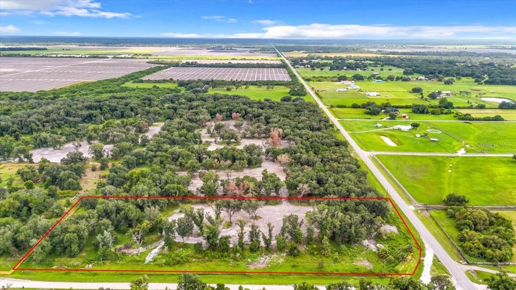 An aerial view shows a rectangular plot of land outlined in red near a road — GILL ROAD, MYAKKA CITY, FL