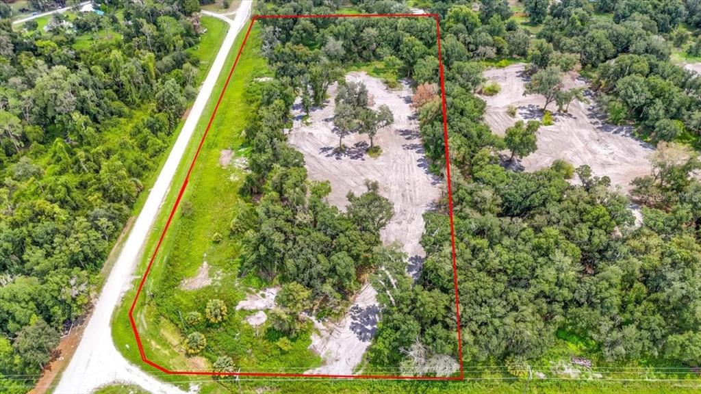 An aerial view shows a rectangular plot of land with cleared sandy areas and trees — GILL ROAD, MYAKKA CITY, FL