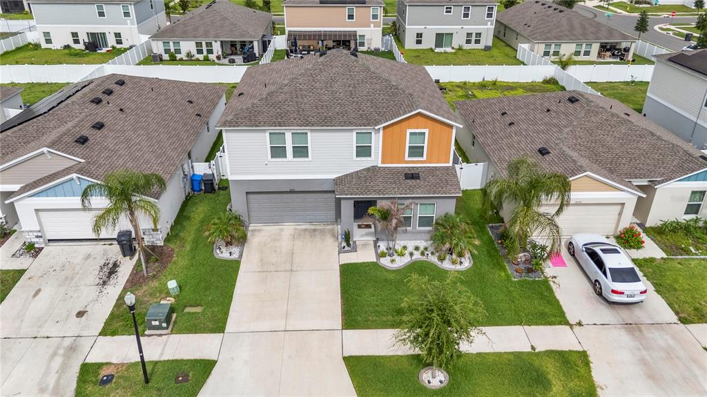 An aerial view of a two-story suburban house with a gray garage and driveway — 12737 TANNENCREST DRIVE, RIVERVIEW, FL