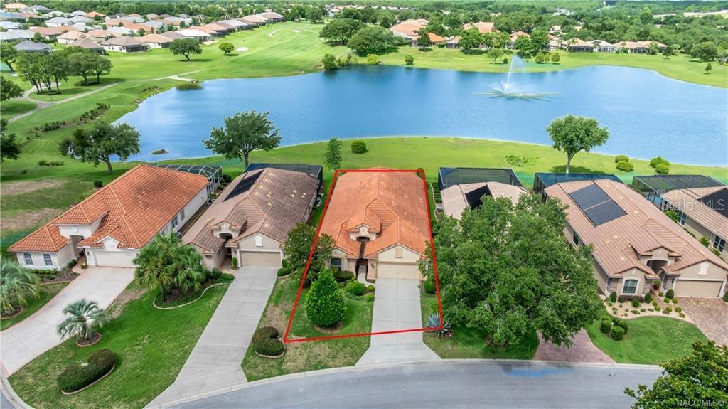 An aerial view of a suburban house with a tile roof situated near a lake — 1328 W DIAMOND SHORE LOOP, HERNANDO, FL