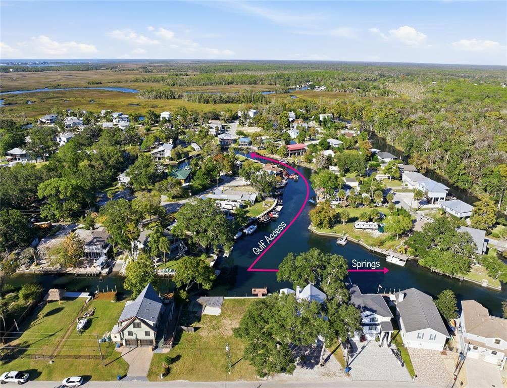 An aerial view shows a residential canal community with arrows indicating directions to the springs — 0 CIRCLE DRIVE, WEEKI WACHEE, FL