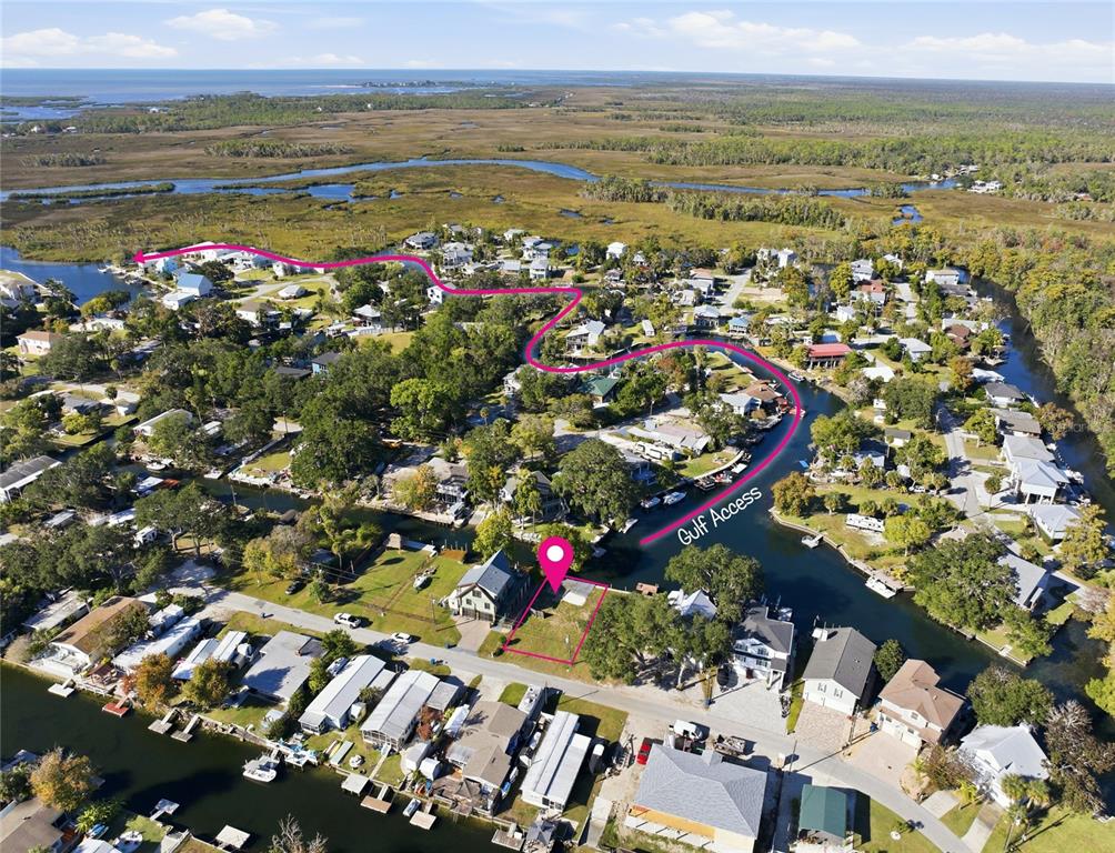 An aerial view shows a vacant waterfront lot marked with a pink pin and outline — 0 CIRCLE DRIVE, WEEKI WACHEE, FL