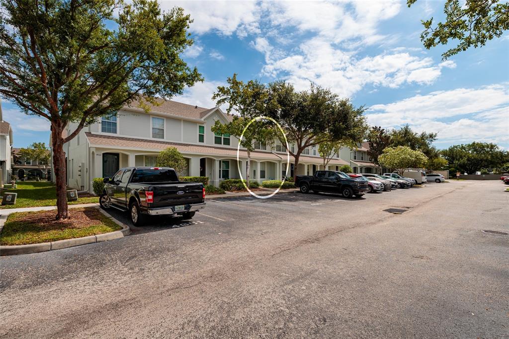 A row of townhomes with a parking lot in front and a tree circled — 4653 66TH PLACE N, PINELLAS PARK, FL
