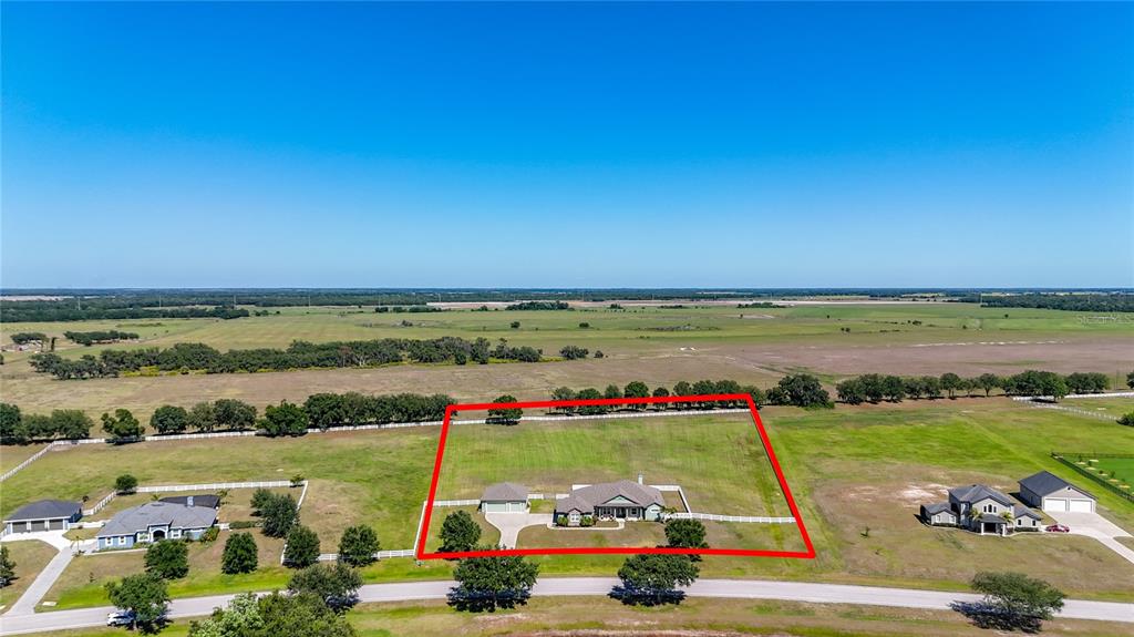 An aerial view shows a house with a detached garage on a large rural lot — 6130 FOXBROOK TRAIL, PARRISH, FL