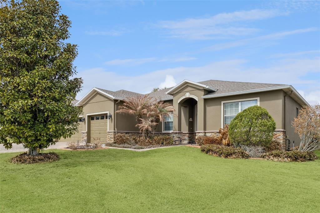 A covered patio with a paver floor, outdoor dining set, and sectional sofa seating area — 2876 SANDY CAY STREET, CLERMONT, FL