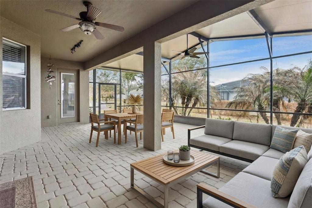 An entryway features tile flooring, a chandelier, a wooden front door, and side rooms — 2876 SANDY CAY STREET, CLERMONT, FL
