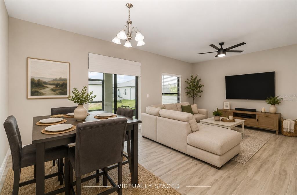 A living and dining room with light wood-look tile flooring and neutral walls — 2841 NW 45TH PLACE, CAPE CORAL, FL