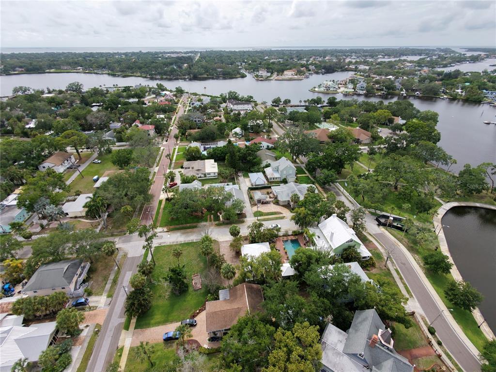 An aerial view shows a residential neighborhood with houses, trees, and a nearby waterway — LEMON STREET, TARPON SPRINGS, FL
