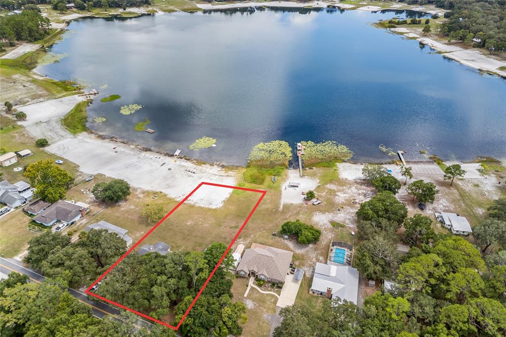 An aerial view shows a rectangular plot of land outlined in red near a lake — 6417 BAKER ROAD, KEYSTONE HEIGHTS, FL