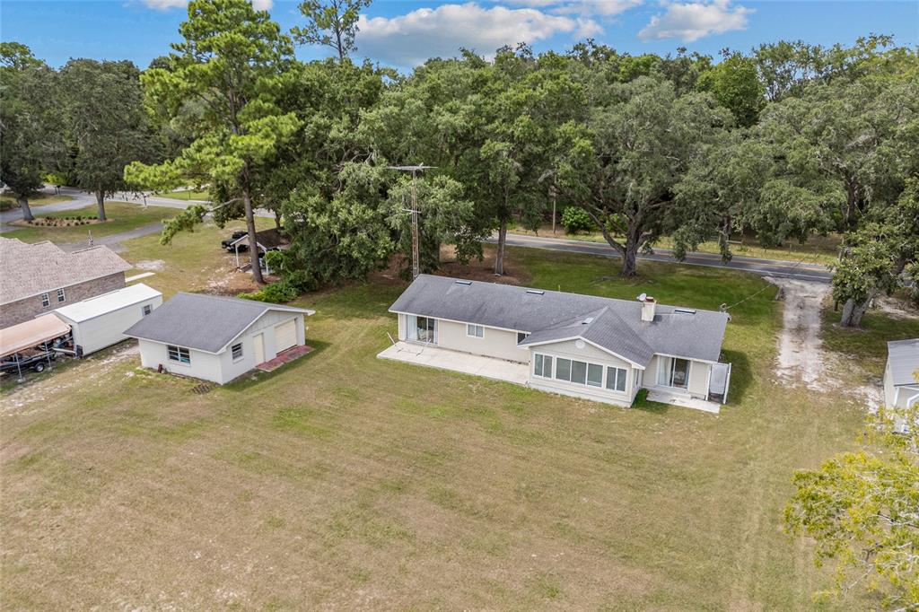 An aerial view shows a single-story house with a detached garage on a grassy lot — 6417 BAKER ROAD, KEYSTONE HEIGHTS, FL