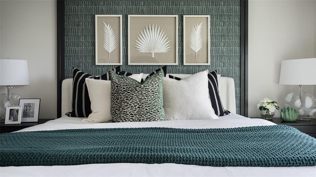 A bedroom features a textured teal accent wall, framed botanical art, and a knitted throw — 36552 SAGEMOOR DRIVE, ZEPHYRHILLS, FL