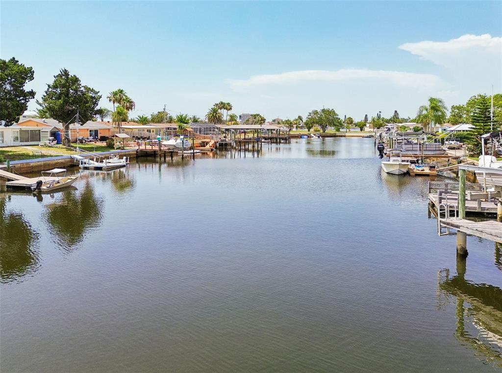 A canal view showing multiple boat docks and residential homes along the waterfront — 12617 4TH ISLE, HUDSON, FL