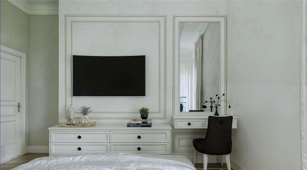 A bedroom features a white dresser, a wall-mounted television, and a built-in vanity with mirror — 12413 HAGFISH COURT, PLACIDA, FL