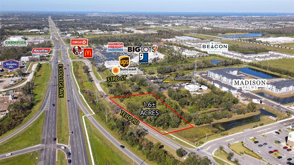 An aerial view shows a vacant 1.6-acre lot outlined in red near a highway intersection — TECO ROAD, RUSKIN, FL