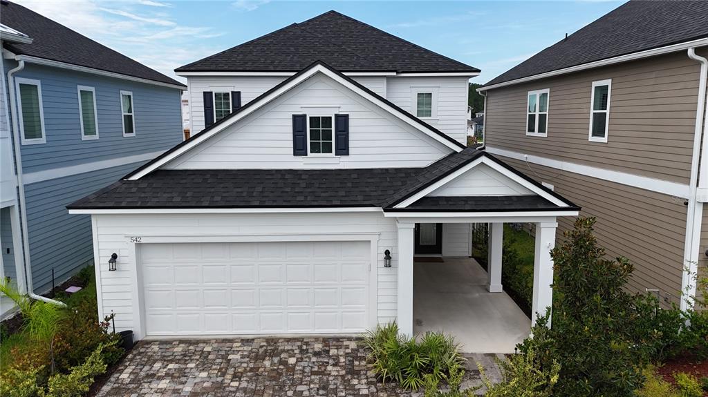 A white two-story house with a front-facing garage and a covered entryway — 542 SILVER LANDING DRIVE, ST AUGUSTINE, FL