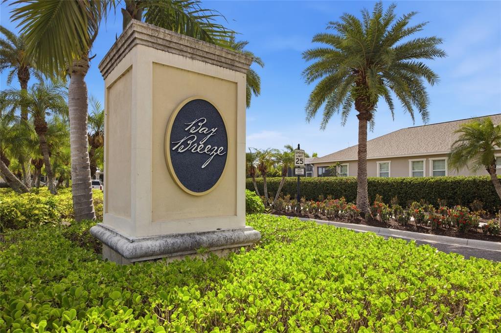 A stone monument sign for Bay Breeze stands in front of palm trees and landscaping — 725 WINTERSIDE DRIVE, APOLLO BEACH, FL