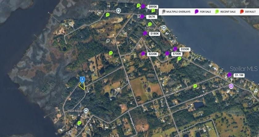 This is a satellite map showing real estate listings and recent sales in a coastal area — N BAKER LANE, JACKSONVILLE, FL