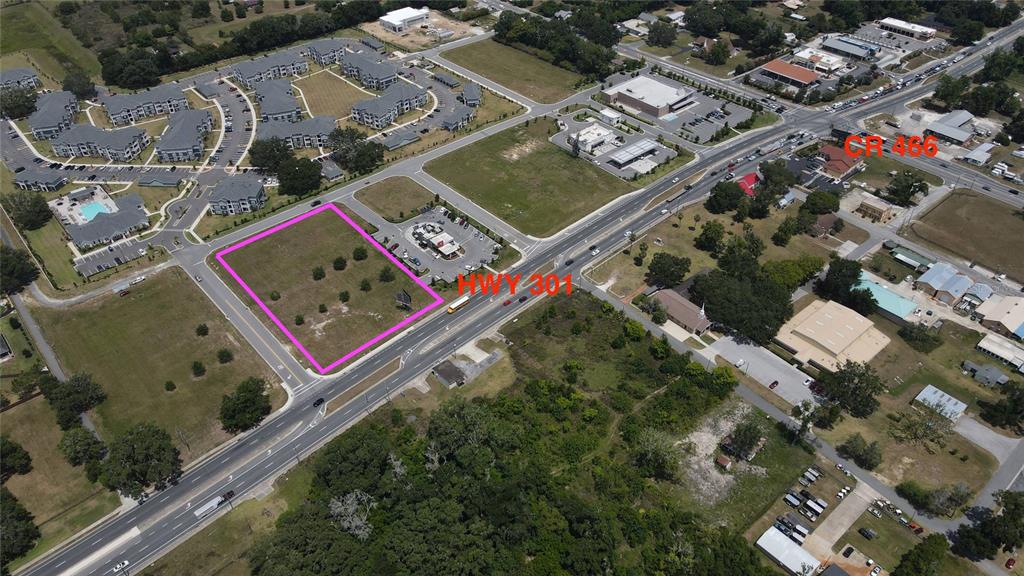 An aerial view shows a vacant rectangular lot outlined in pink along a major highway — 11532 N US HIGHWAY 301, OXFORD, FL