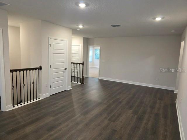 A modern kitchen features light gray cabinets, white quartz countertops, and a central island — 11827 SHINE VIEW LANE, WINTER GARDEN, FL
