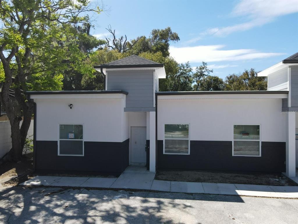A modern one-story building with a gray and white exterior and a central entryway — 705 S ORANGE AVENUE, BARTOW, FL