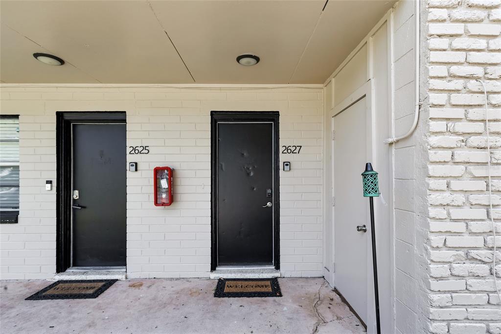 An empty room features light gray walls, a ceiling fan, and wood-look tile flooring — 2621 SW 33 AVENUE, OCALA, FL
