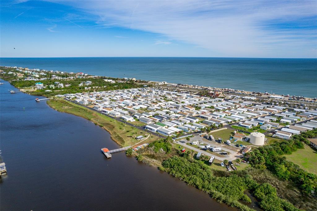An aerial view shows a dense residential community situated between a river and the ocean — 225 STARBOARD DRIVE, FLAGLER BEACH, FL