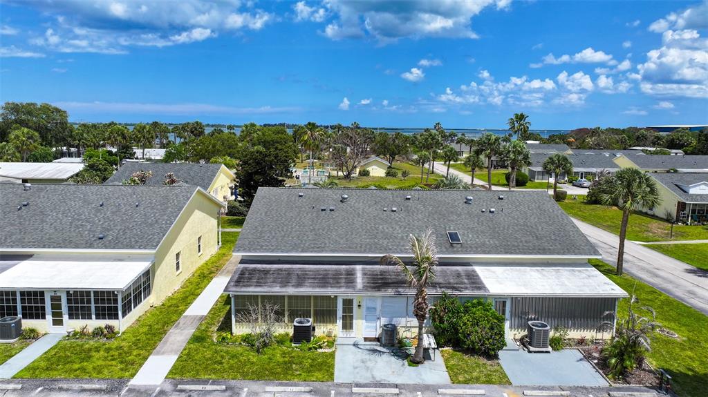An aerial view shows the exterior of a single-story residential building with a gray roof — 8520 US HIGHWAY 1 UNIT D3, MICCO, FL