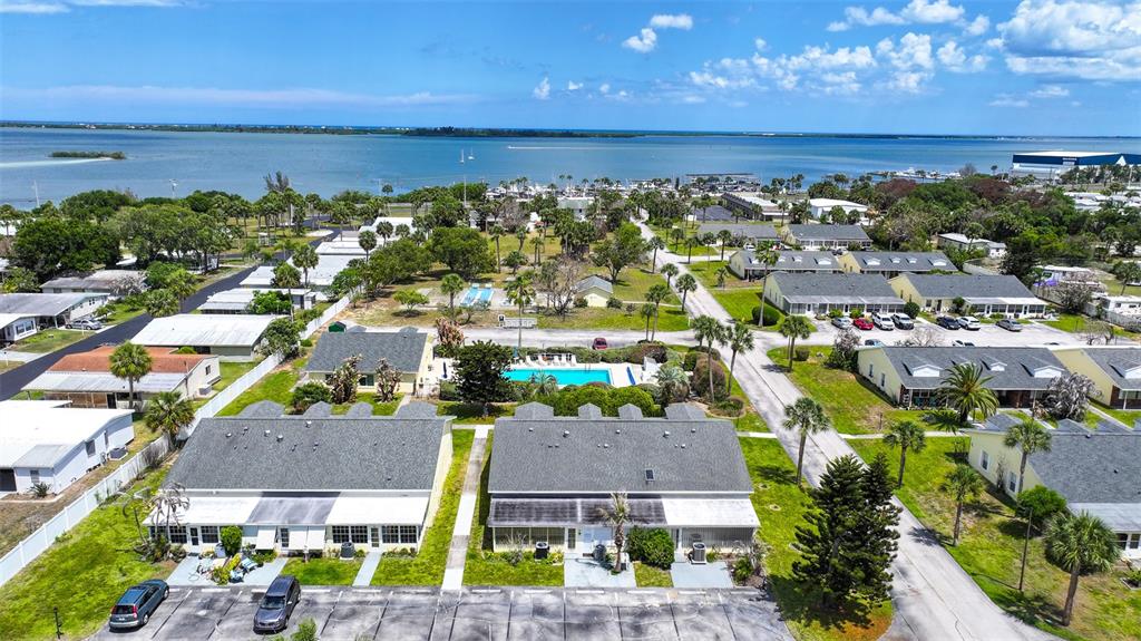 An aerial view shows a residential complex with multiple buildings, a swimming pool, and parking — 8520 US HIGHWAY 1 UNIT D3, MICCO, FL