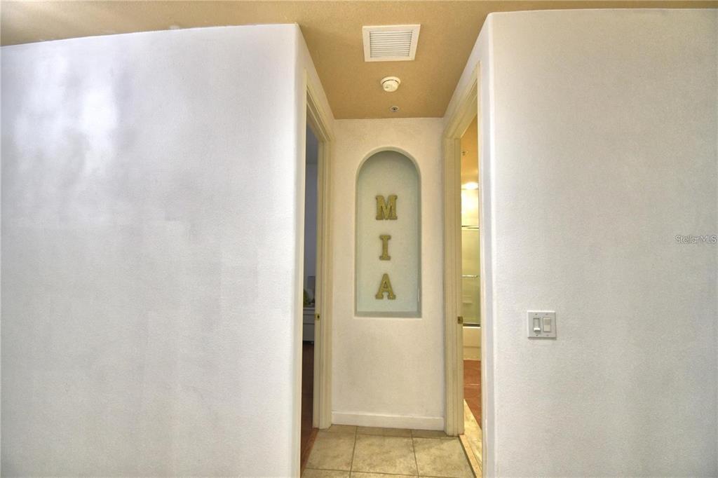 A hallway features a recessed arched niche displaying the letters M, I, and A — 8743 THE ESPLANADE UNIT 8, ORLANDO, FL