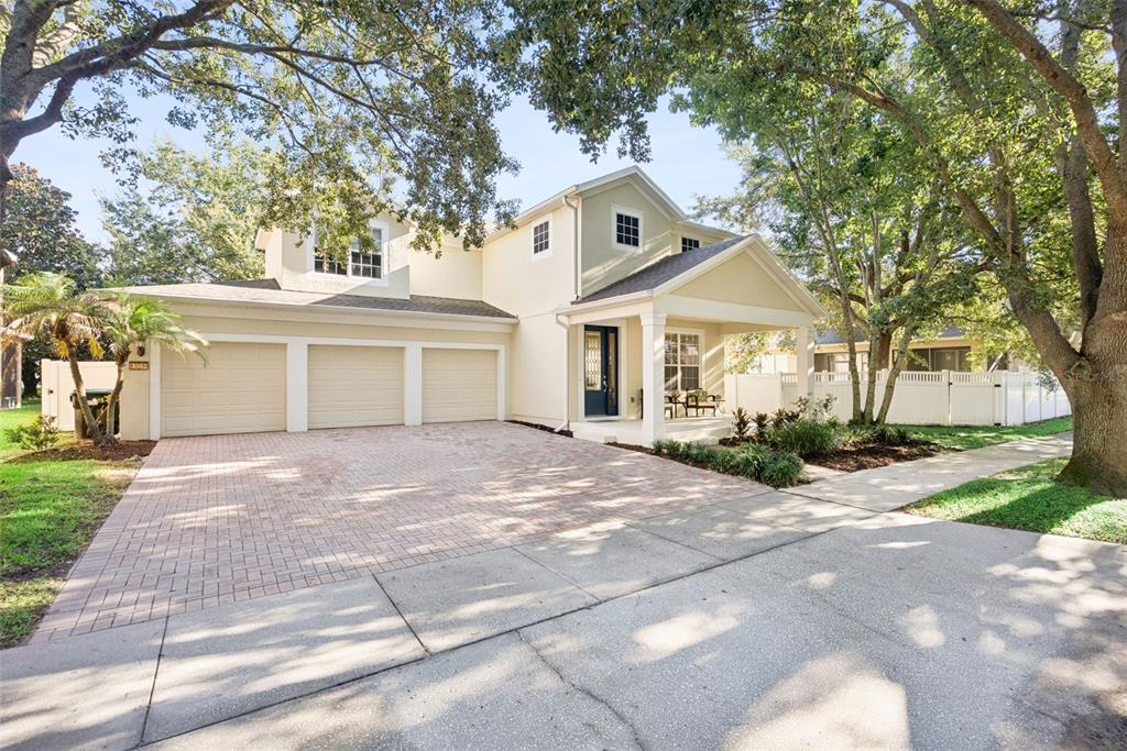 A two-story house with a three-car garage, a covered front porch, and a paved driveway — 13239 JERVEY STREET, WINDERMERE, FL