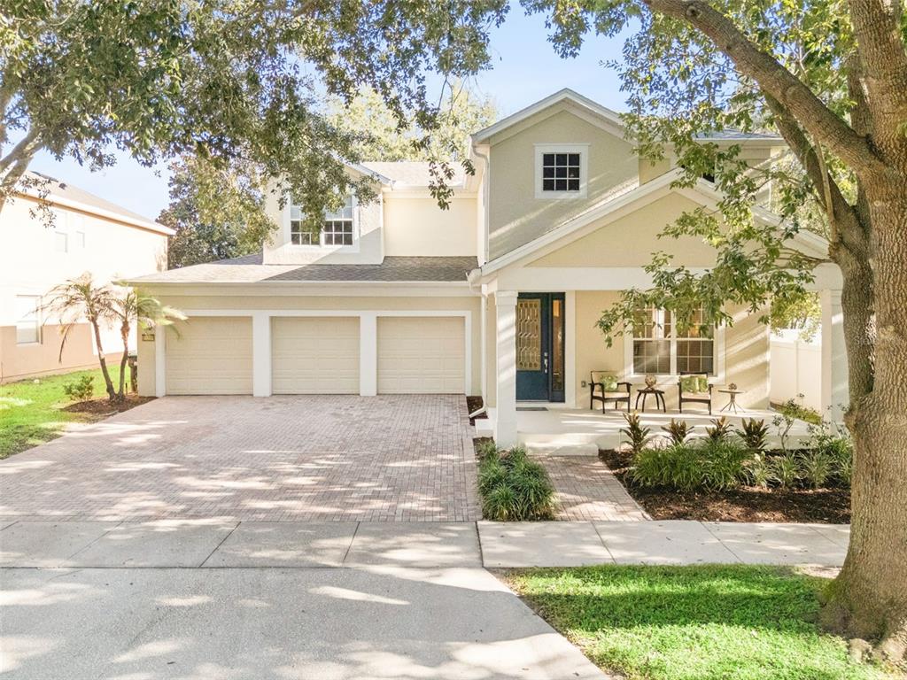 A two-story house with a three-car garage, a covered front porch, and a paved driveway — 13239 JERVEY STREET, WINDERMERE, FL