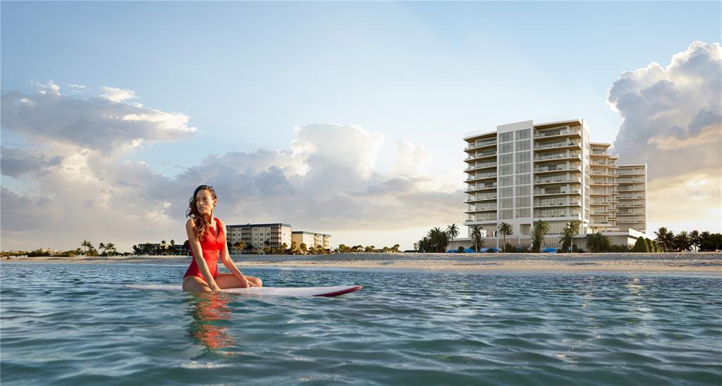 This rendering shows a woman on a surfboard in the ocean before a beachfront condominium building — 1000 BENJAMIN FRANKLIN DRIVE UNIT 404, SARASOTA, FL