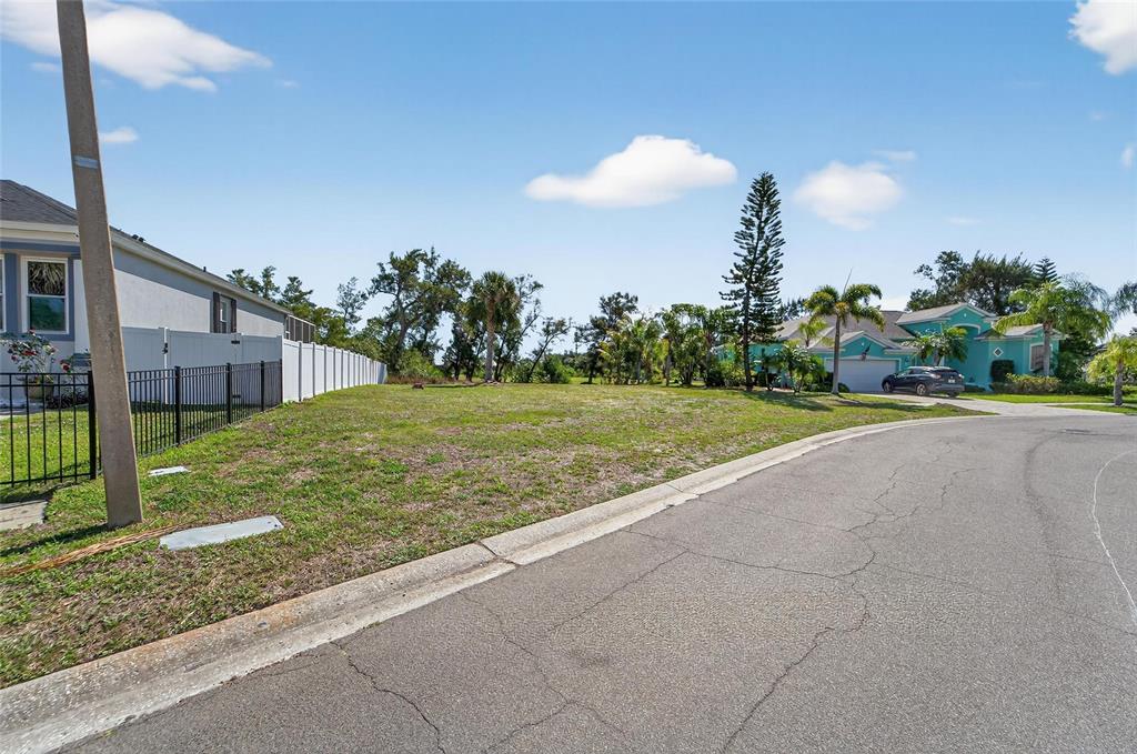 A vacant residential lot sits between two houses along a paved suburban street — 806 GREENVIEW DRIVE, APOLLO BEACH, FL