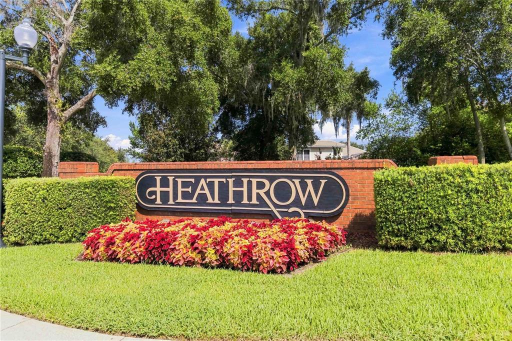 A brick monument sign with the word Heathrow sits in front of hedges and trees — 1038 WESTBURY WAY, LAKE MARY, FL