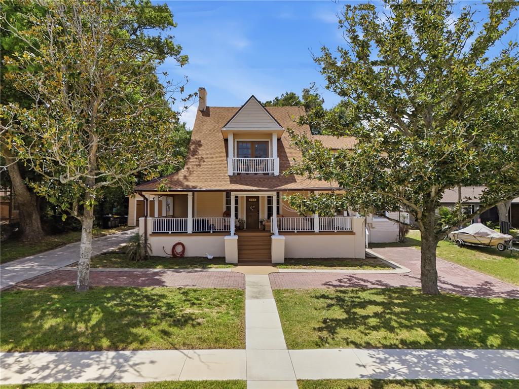 A two-story house with a large front porch, a balcony, and a brick driveway — 535 W OSCEOLA STREET, CLERMONT, FL