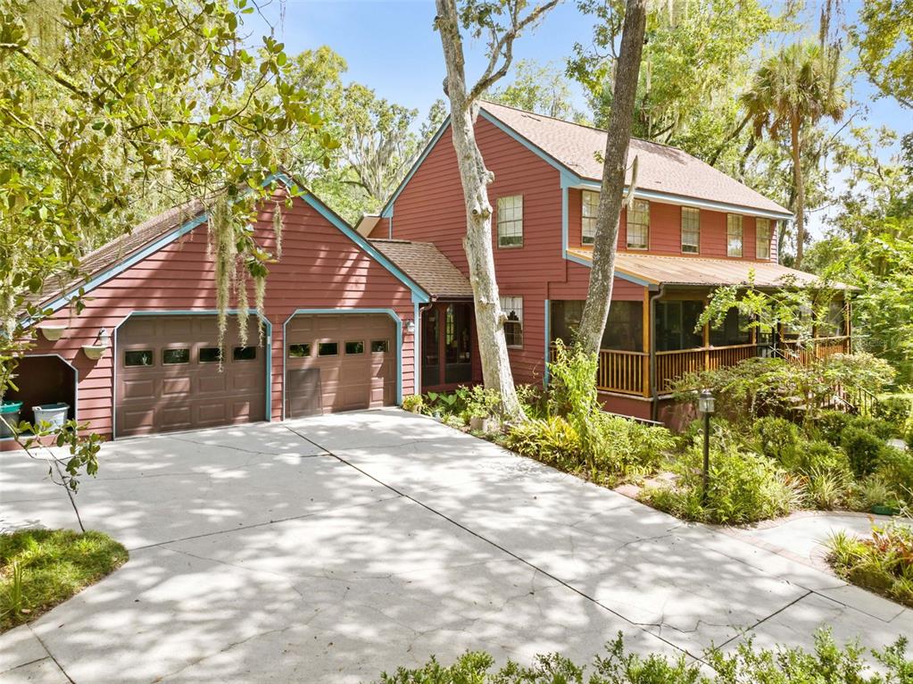 A two-story red house with a two-car garage and a screened-in porch — 20485 YONTZ ROAD, BROOKSVILLE, FL