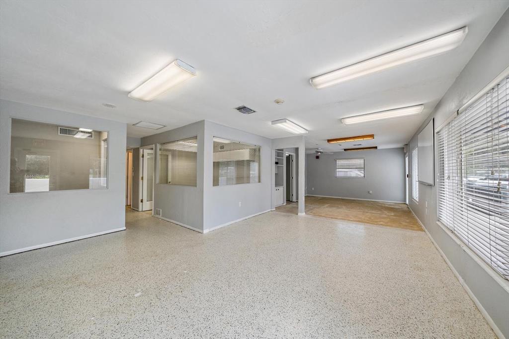 An office space with light gray walls, speckled flooring, and several interior glass partitions — 4242 MCINTOSH LANE, SARASOTA, FL