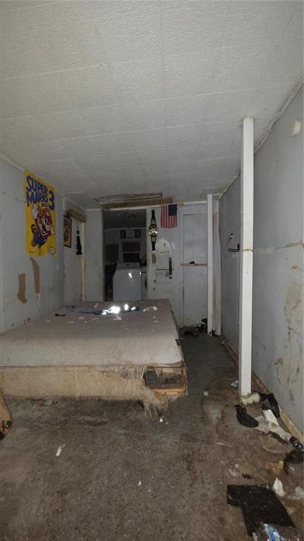 A dilapidated room features a mattress on the floor, exposed wall studs, and unfinished surfaces — 3000 CLARCONA ROAD UNIT 510, APOPKA, FL