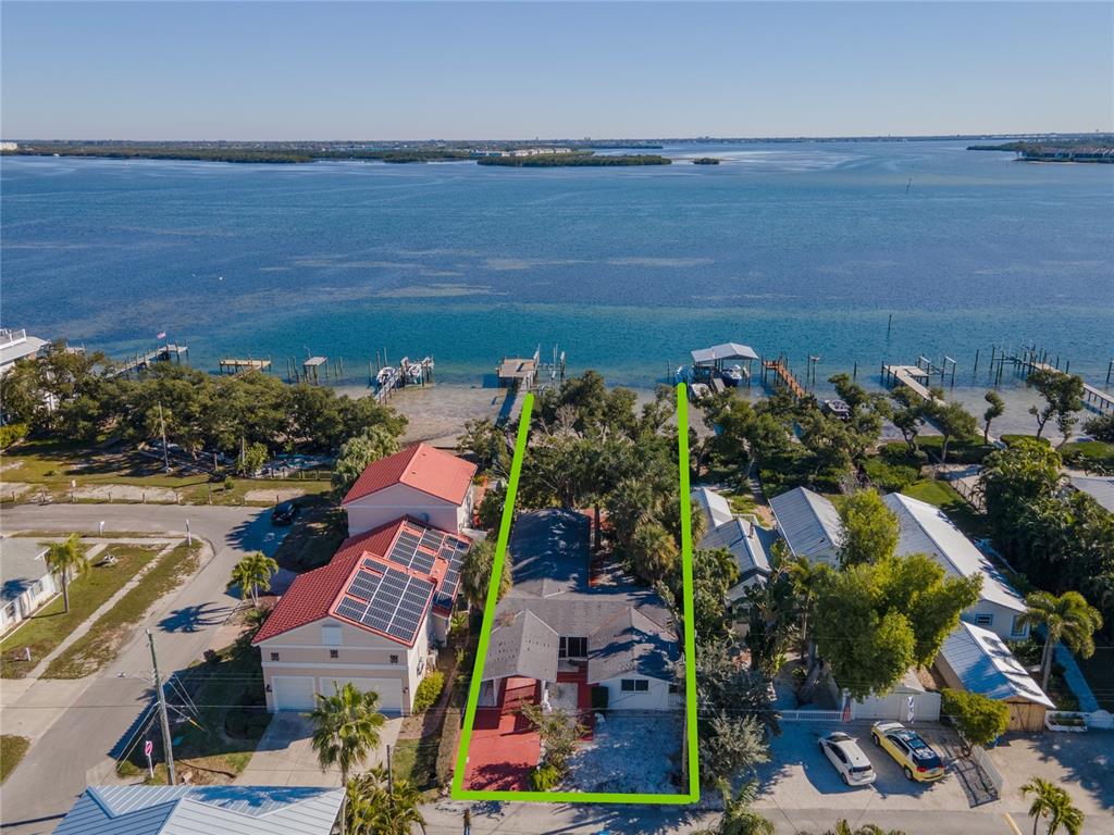 An aerial view shows a waterfront house with a green outline marking the property boundaries — 2316 CANASTA DRIVE, BRADENTON BEACH, FL