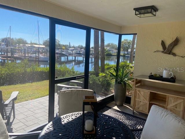 A screened-in porch overlooks a marina with boats docked on the water — 646 YARDARM DRIVE UNIT 23, APOLLO BEACH, FL
