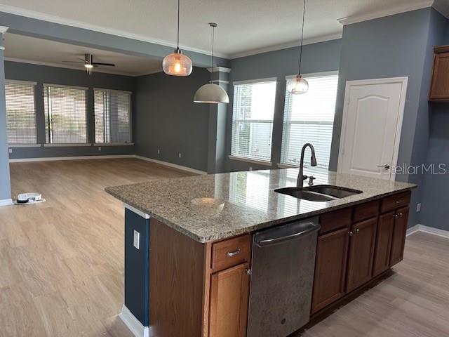 A kitchen island with granite countertops and a stainless steel dishwasher faces an open living area — 16758 ABBEY HILL COURT, CLERMONT, FL