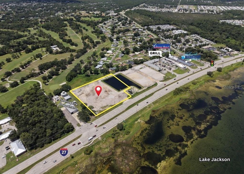 This aerial map shows a vacant lot outlined in yellow next to a highway — 1025 US-27 S, SEBRING, FL